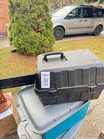 Closed black hard case on storage bins