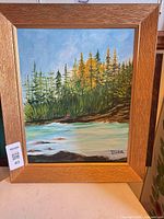 Full view of framed landscape painting