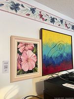Both framed paintings on wall