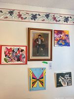 Wall view of all five framed artworks