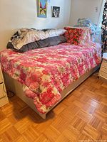 Full view of single bed with frame, mattress and bedding