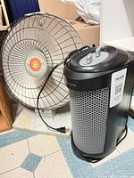 Front view showing Presto HeatDish and Bionaire tower heater together