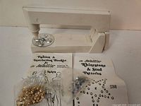 Bedazzler tool, studs, booklets overall view