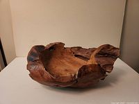 Oblique view of wooden burl bowl showing live edge and interior