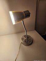 Lamp illuminated showing shade, gooseneck and base