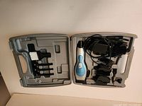 Open case showing clipper, charger, guards, brush and clips