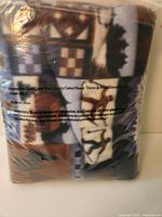 Front of sealed package showing cabin motif pattern and product text