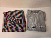 Pajama bottoms folded beside grey T-shirt
