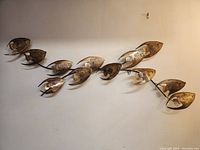 Front view showing full length of metal fish wall sculpture