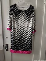 Front view of geometric dress showing pattern, neckline and pink trim