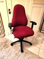 Front three-quarter view of burgundy adjustable office chair