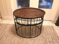 Full view of assembled table showing rattan top and metal base
