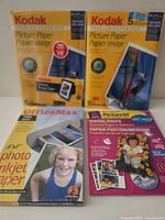 Four sealed packs of photo paper