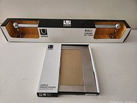 Boxed Umbra 18" Bali towel bar and boxed 5×7 photo frame