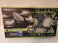 Front of retail box showing drone image and feature icons