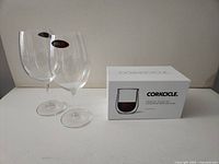 Two Riedel stemmed glasses and unopened Corkcicle box