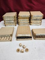 Stacked cardboard boxes of Majestic shuttle bobbins, some opened to show contents