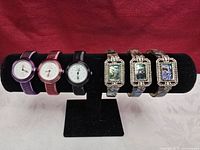 All six wristwatches on display stand