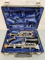 Open case with clarinet joints, barrel, bell and swab