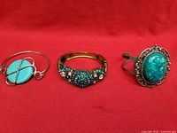 Front view of three jewelry pieces on red background