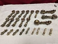 All 27 metal utensil rests arranged in rows