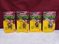 All four sealed TMNT keychains on cards