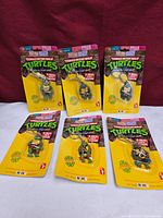 Group shot of six sealed TMNT Hope keychains