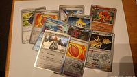 Group of ten Pokémon cards fanned out on table