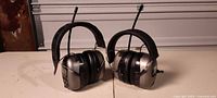 Two Safety Works AM/FM radio headphones side by side on table