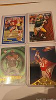 All four football cards in hard sleeves