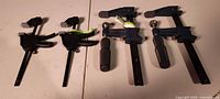 All four Pittsburgh bar clamps on table, showing sizes and condition