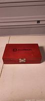 Closed red wooden Alltrade box