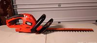 Full view of Black & Decker hedge trimmer lying on table