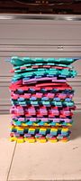 Stack of multicolor interlocking foam tiles