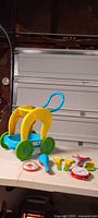 Overall lot showing walker cart and six musical toys