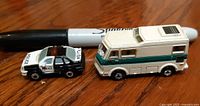 Police car and motorhome side view with marker for scale