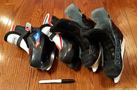 Both pairs of toddler skates side by side with marker for scale