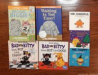 All seven books front covers displayed on wooden floor