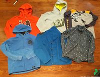 All six long sleeve tops laid out on floor