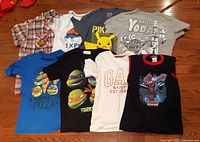 Group shot of eight boys shirts laid out