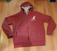 Front view of red Kangol zip hoodie laid flat