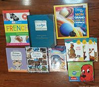 Group shot of assorted French children’s books showing dictionaries, picture books, National Geographic Kids space book, and several storybooks