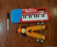 Keyboard, rattle, and scale marker on hardwood floor