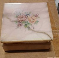 Top view of closed alabaster box showing floral motif and hairline crack