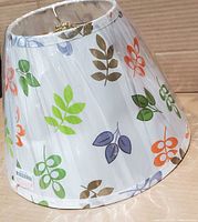 Full view of tapered leaf-print lamp shade in plastic wrap
