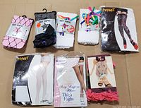 All eight packaged hosiery items laid out on cardboard