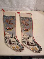 Front view showing both needlepoint stockings and design details