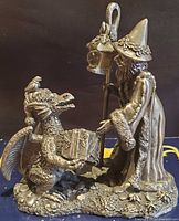 Front view of pewter wizard giving gift to dragon