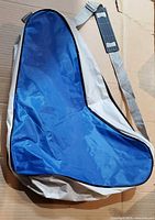 Front view of triangular blue and gray sling bag