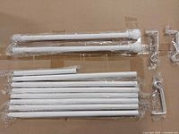 Two long rods, ten short rod sections, three brackets in plastic